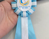 In Logo Trên Hoa Cài Áo Đại Biểu – Xưởng May Cờ Hoàng Gia Hà Nội